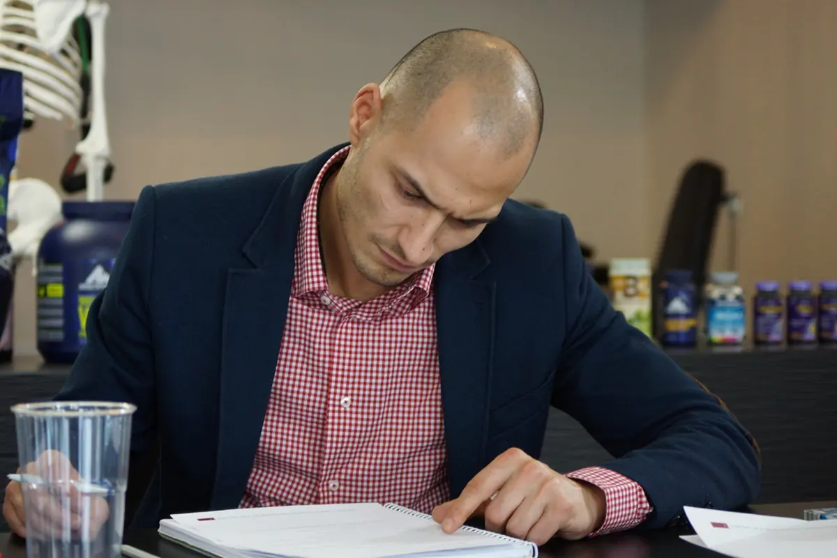 Workshop participant studying AI strategy materials during professional coaching session at SNF Academy