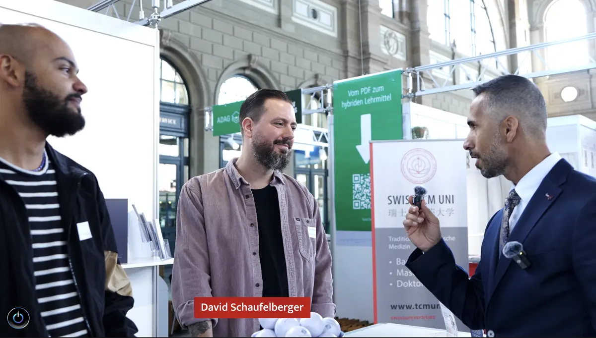 Birol Isik conducting interview with David Schaufelberger at Zurich education expo for digital skills and AI training