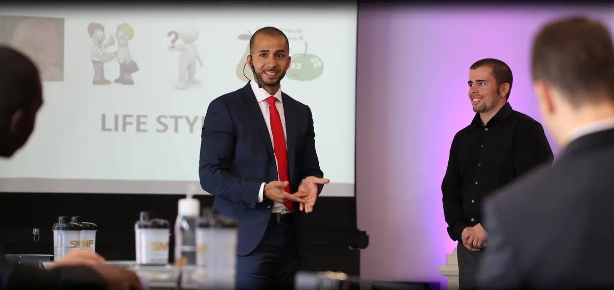 Birol Isik delivering AI consulting presentation with red tie at professional seminar for digital transformation coaching